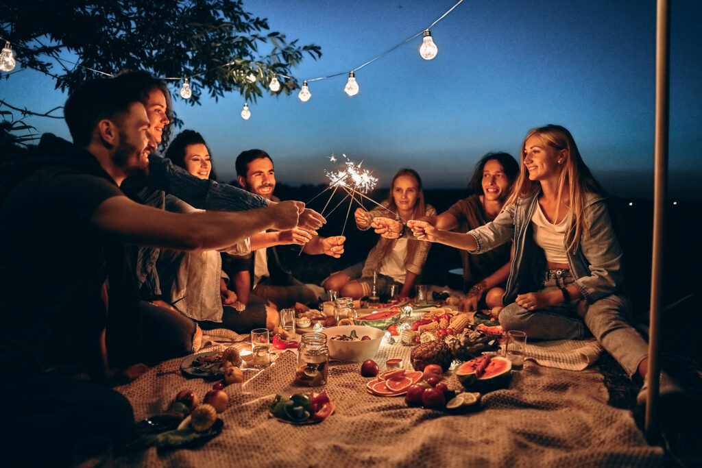 Group of friends having fun around a picnic
