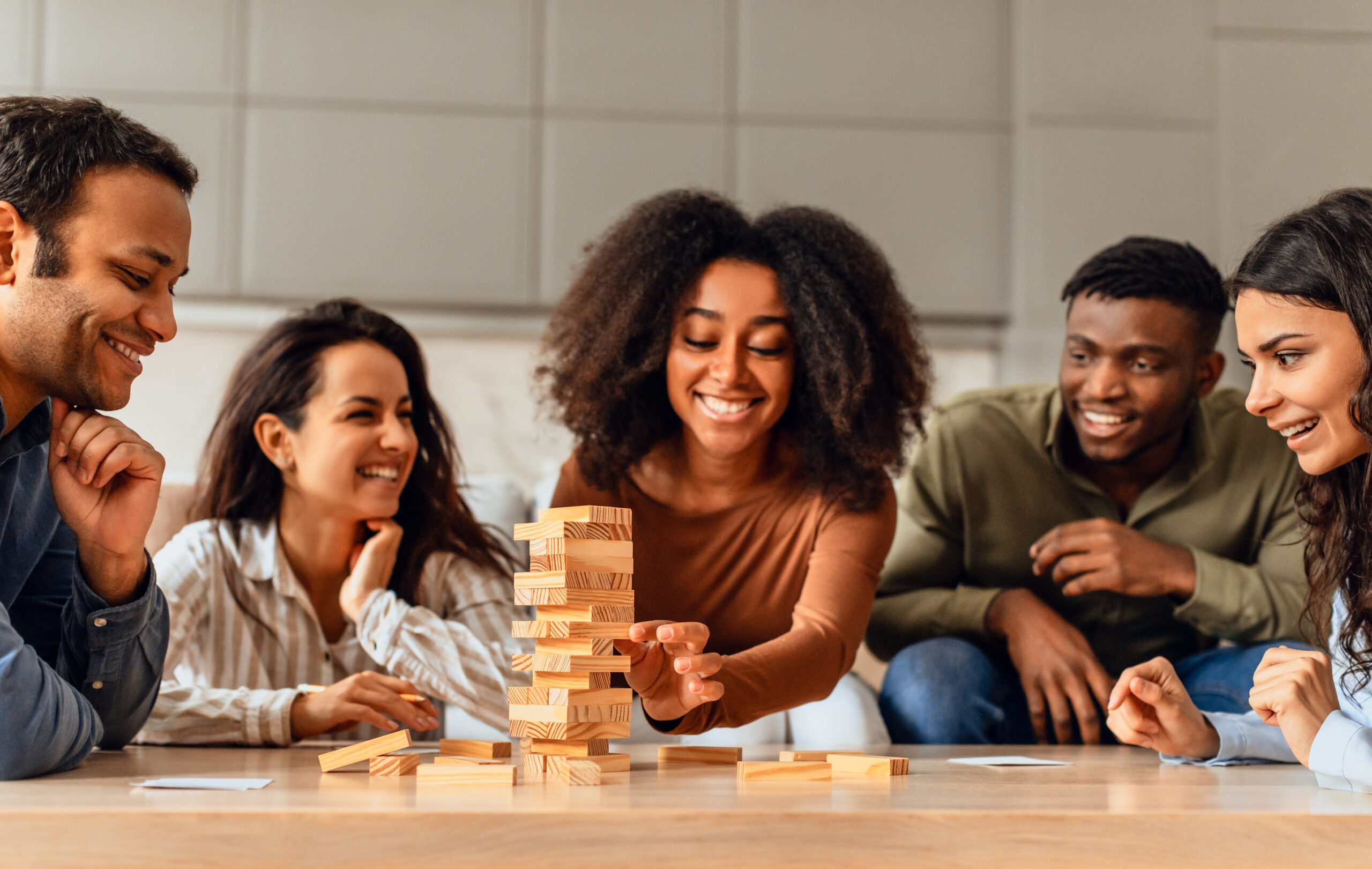 friends around table in kitchen engaging in board game