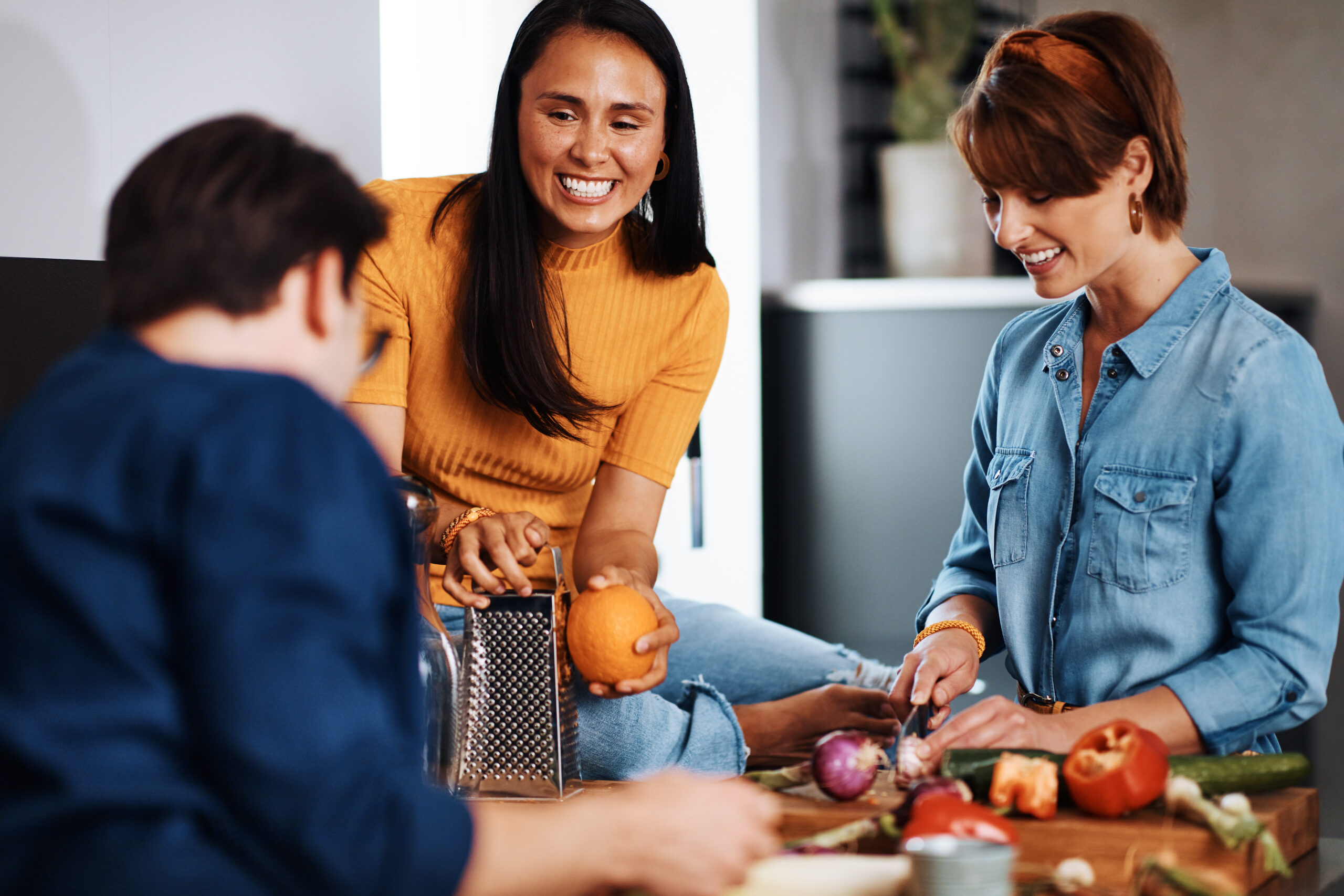 diverse friends making dinner together